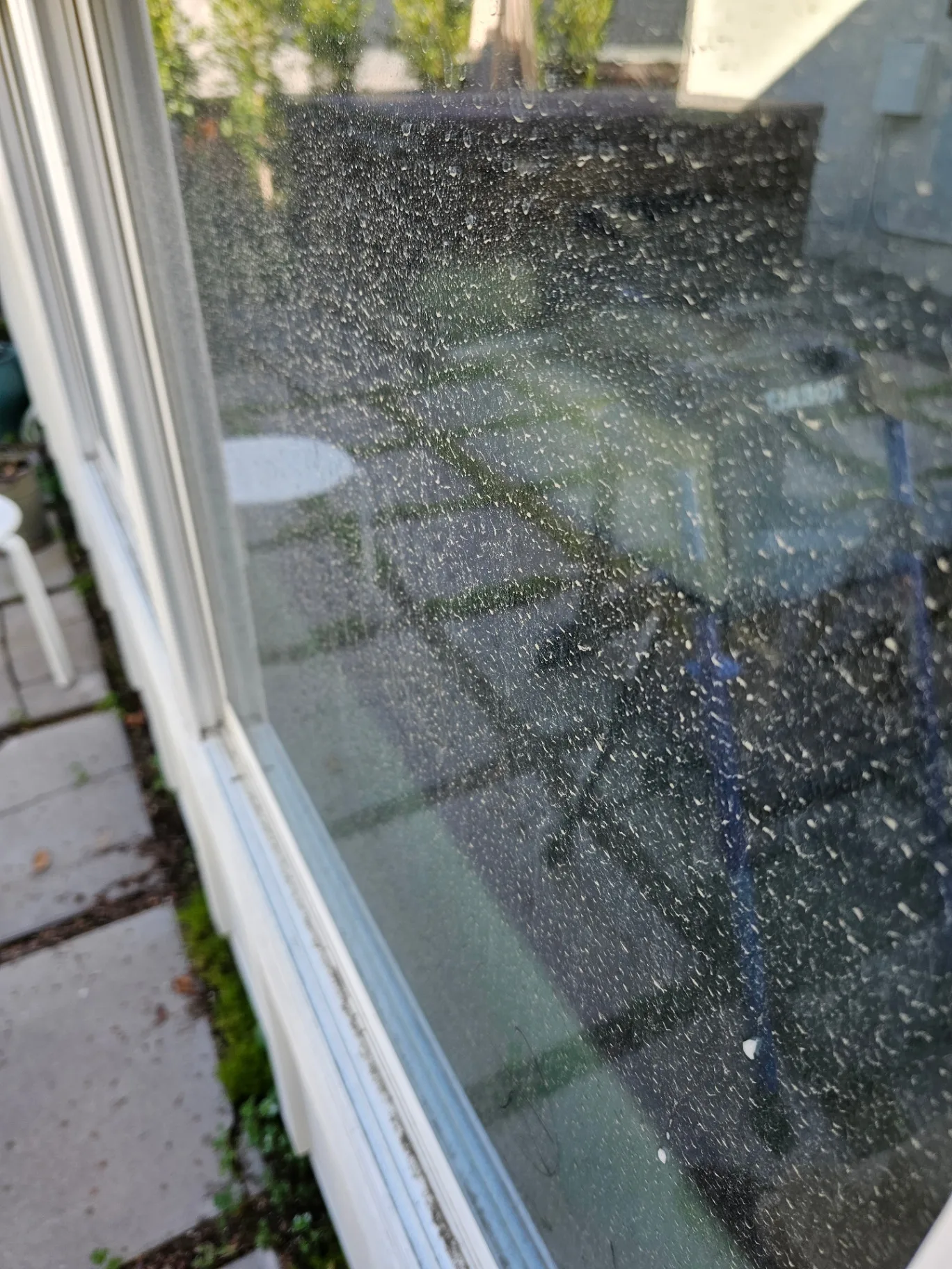Exterior window glass covered in hard water spots before Transparent Solutions cleaning