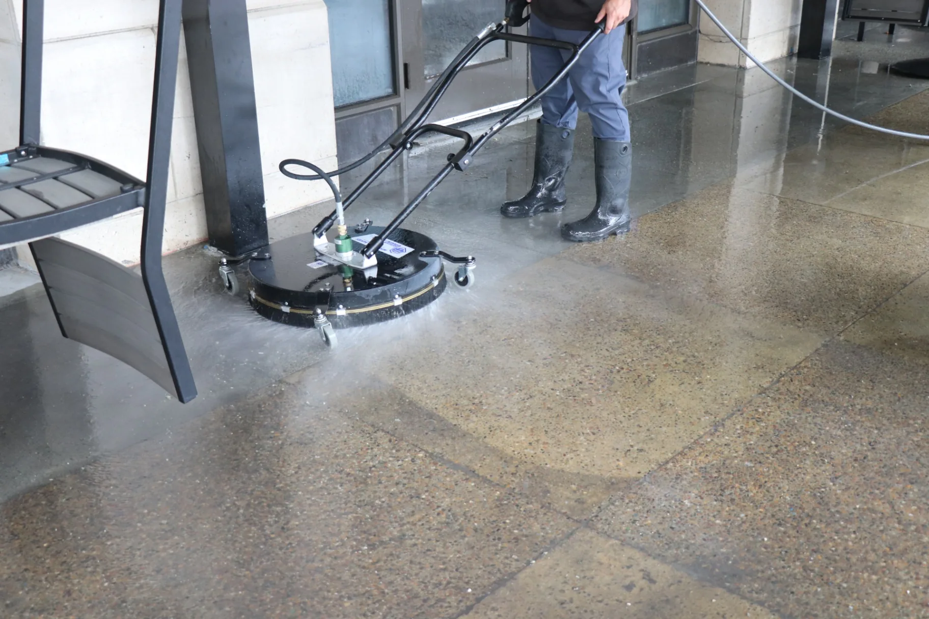 Surface cleaner removing grime from a commercial concrete entryway