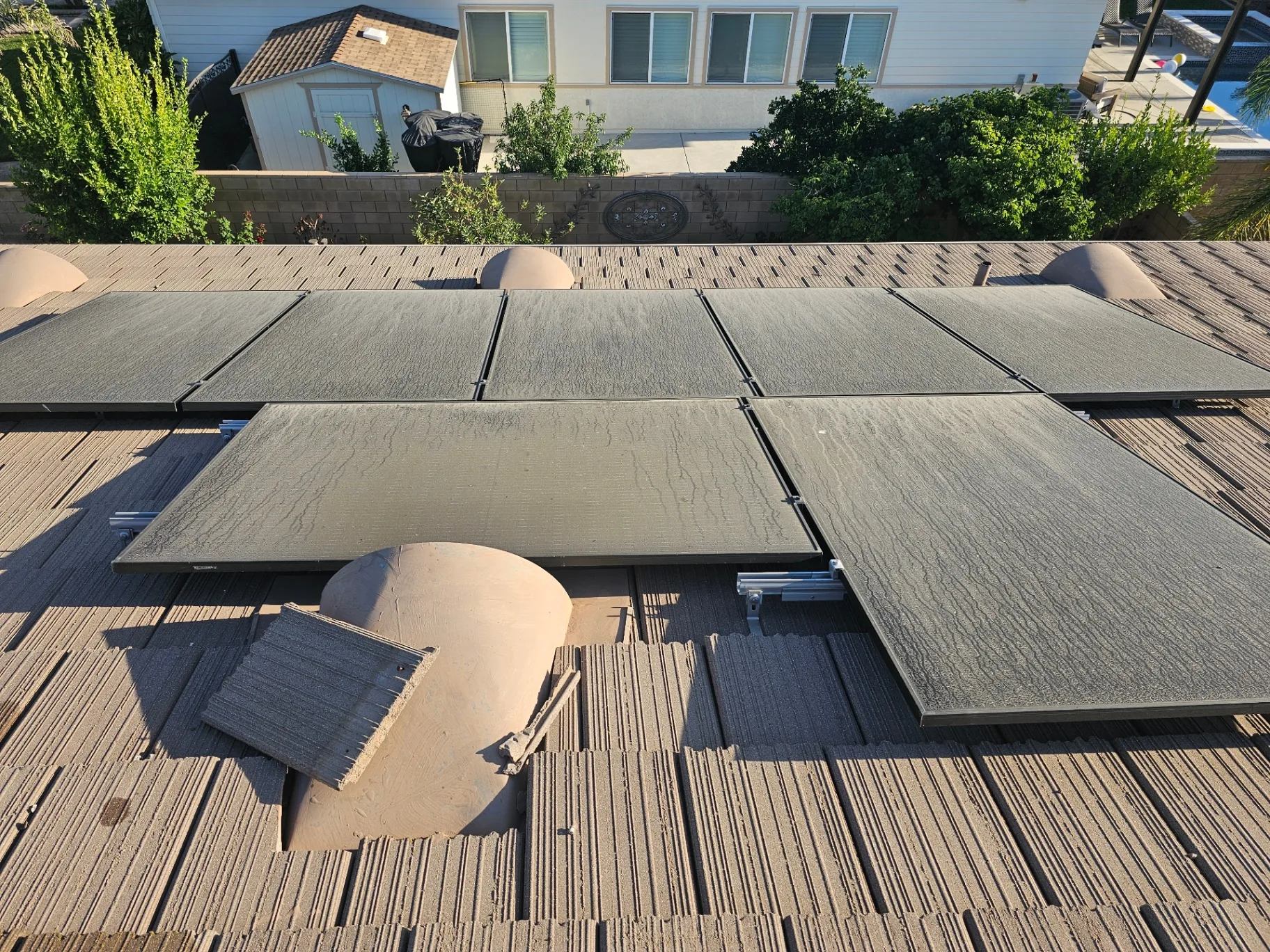 Heavily soiled solar panels with water streaks before professional cleaning