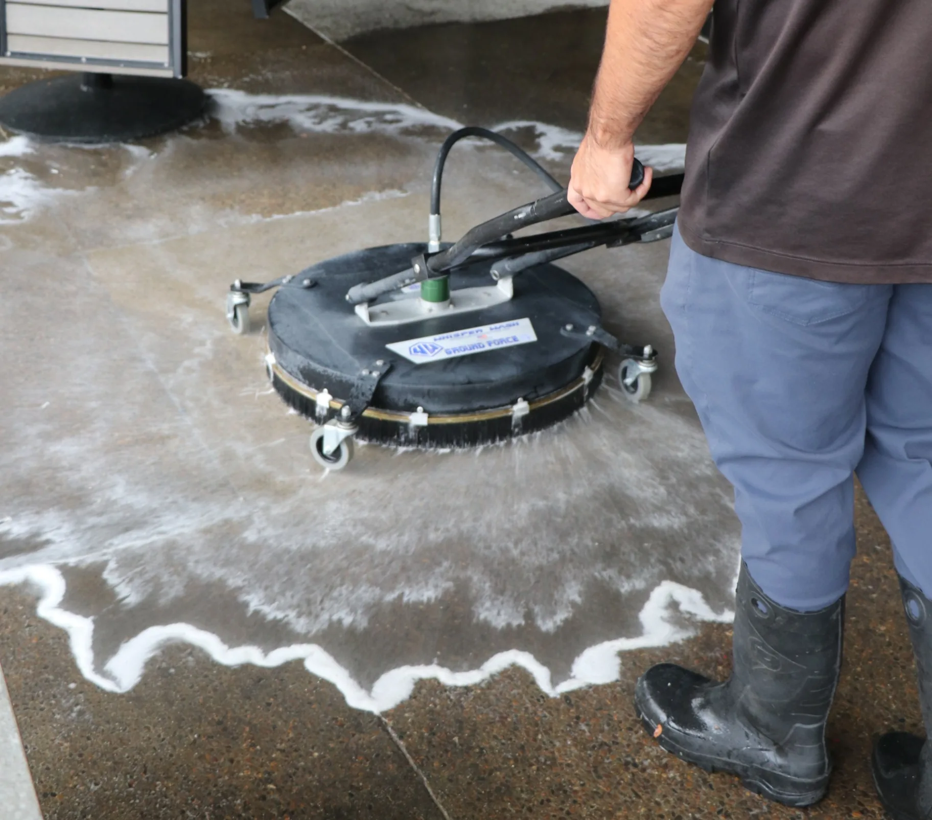 Transparent Solutions technician surface cleaning commercial concrete with visible foam
