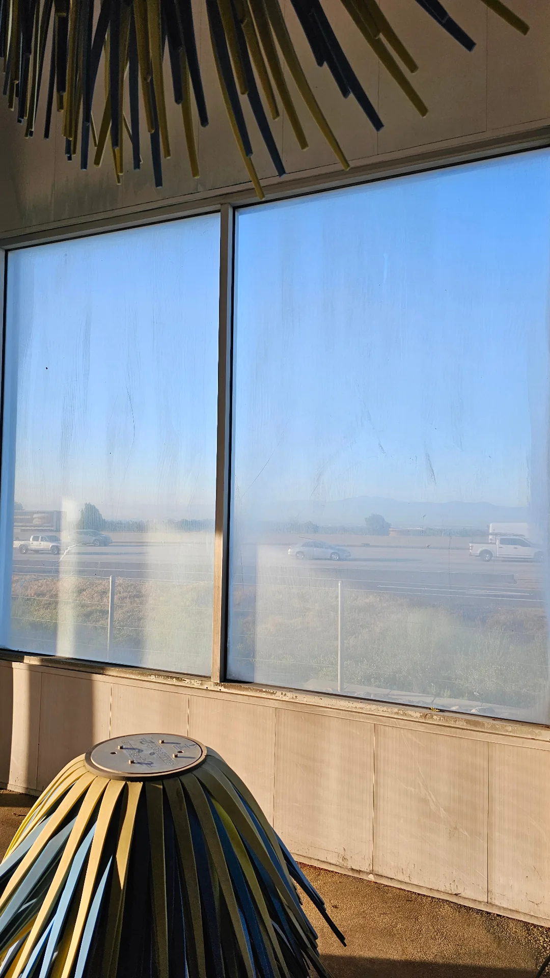 Commercial windows hazed over by hard water film before professional restoration