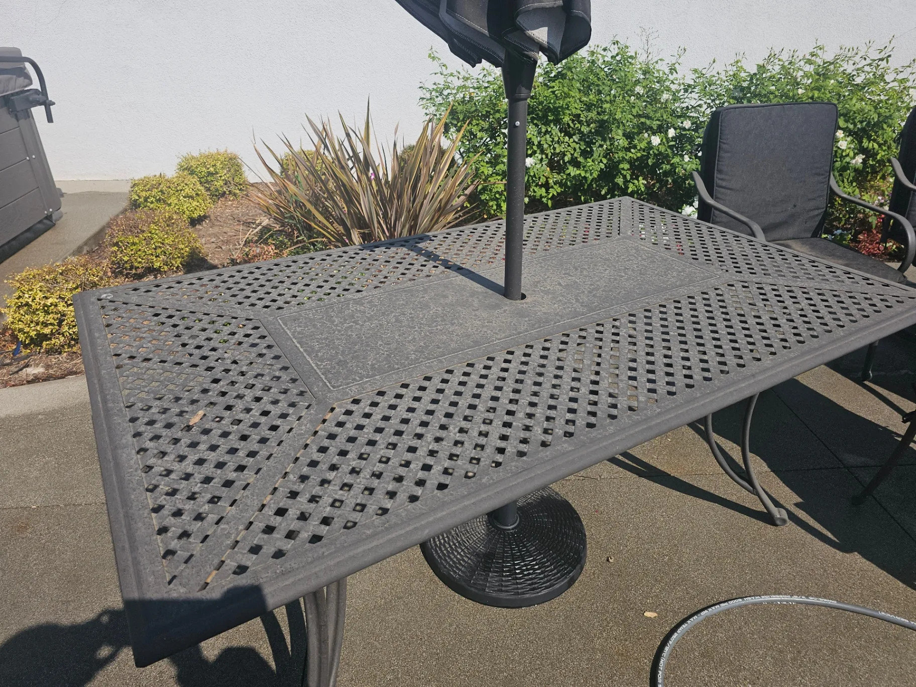 Before photo of a dirty patio table with organic buildup, prior to a Transparent Solutions soft wash