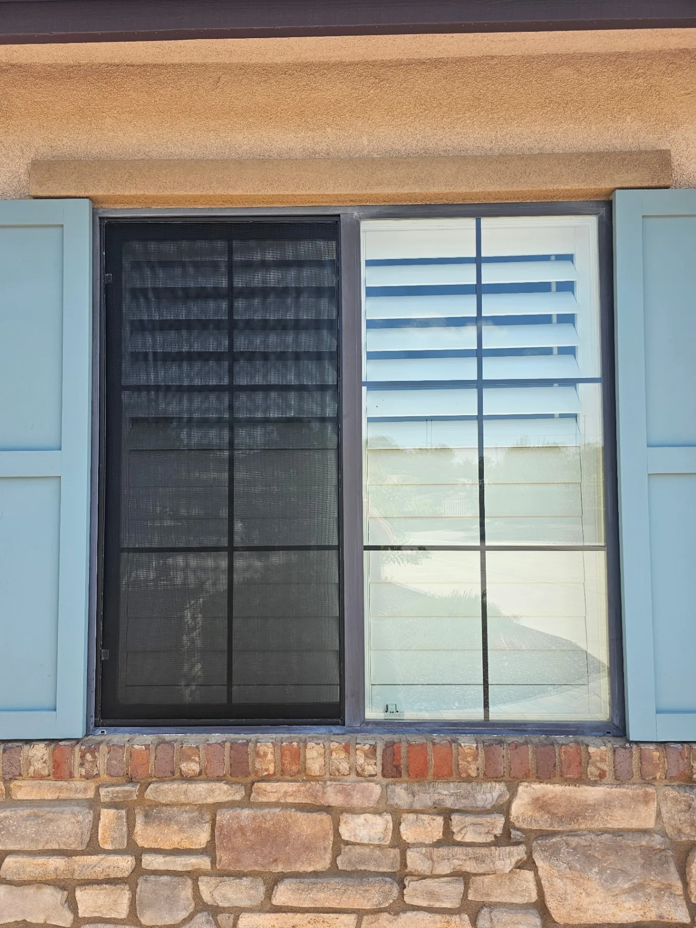 Finished screen replacement showing a clean new black mesh patio screen alongside a freshly cleaned window