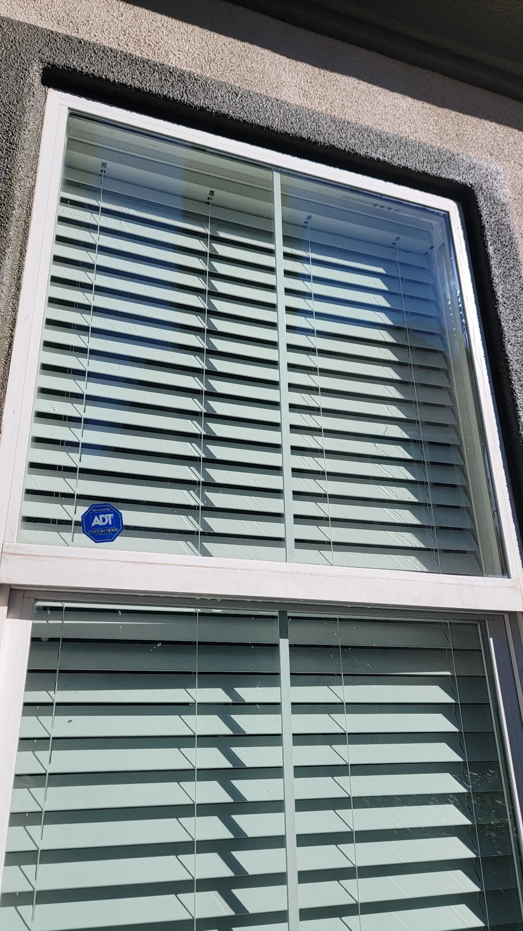 Same residential window cleared of hard water stains after Transparent Solutions restoration