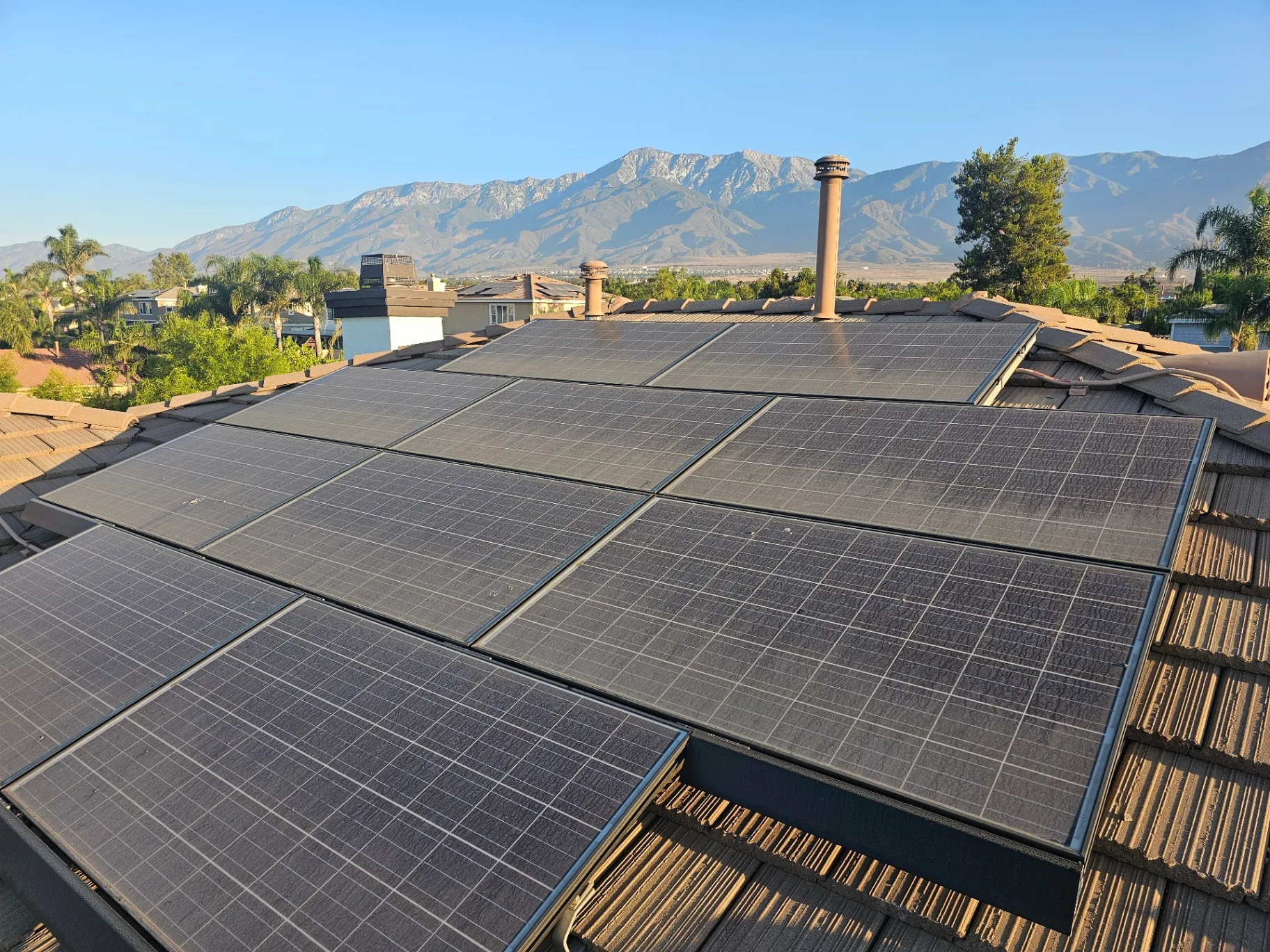 Dirty roof-mounted solar panels covered in dust before professional cleaning