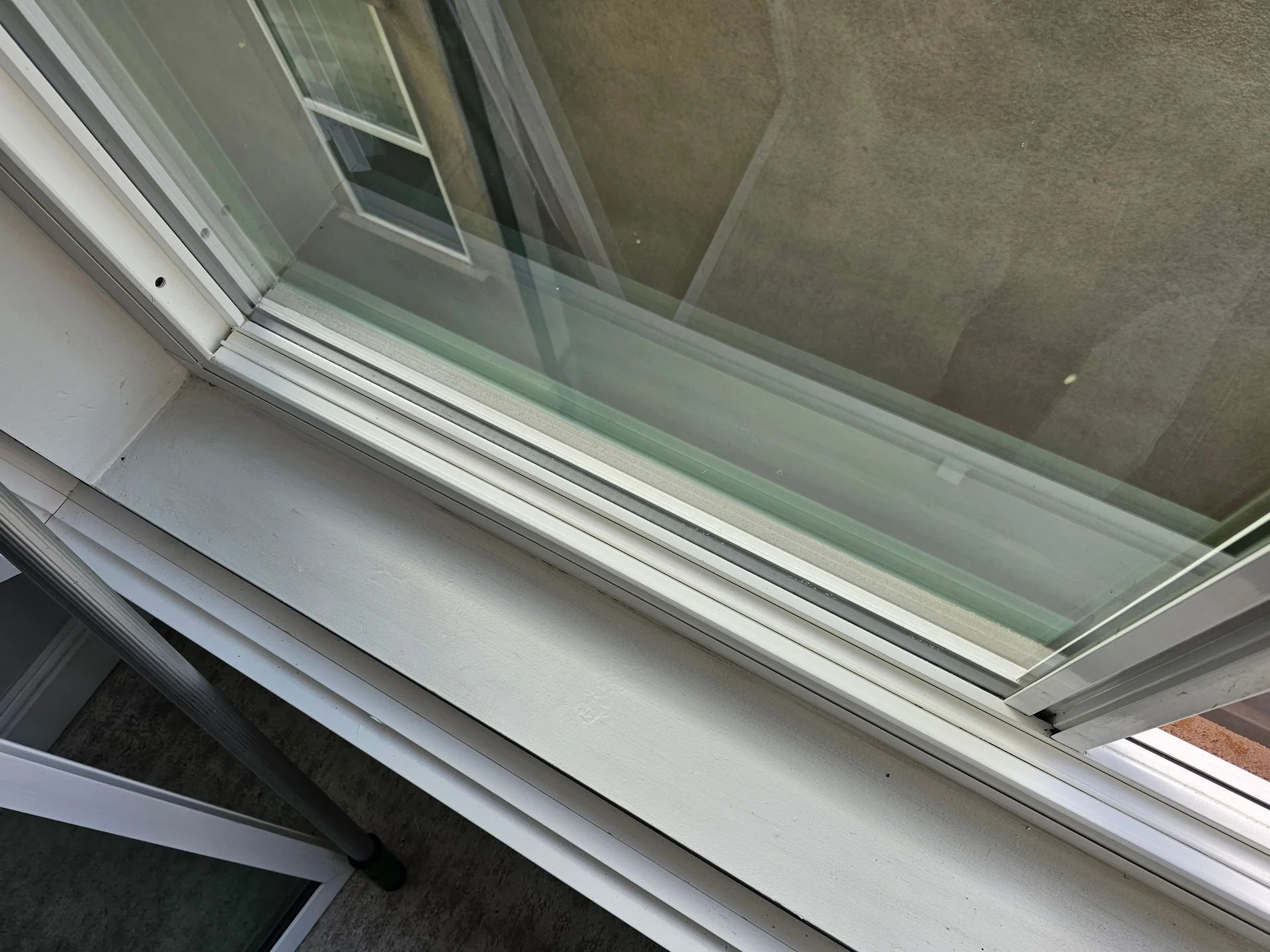 Clean window track after a Transparent Solutions track deep cleaning service