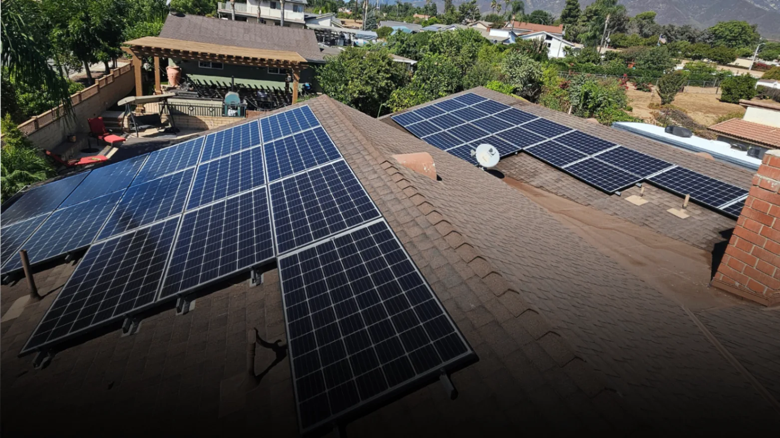 Aerial view of clean residential solar arrays on a tile roof