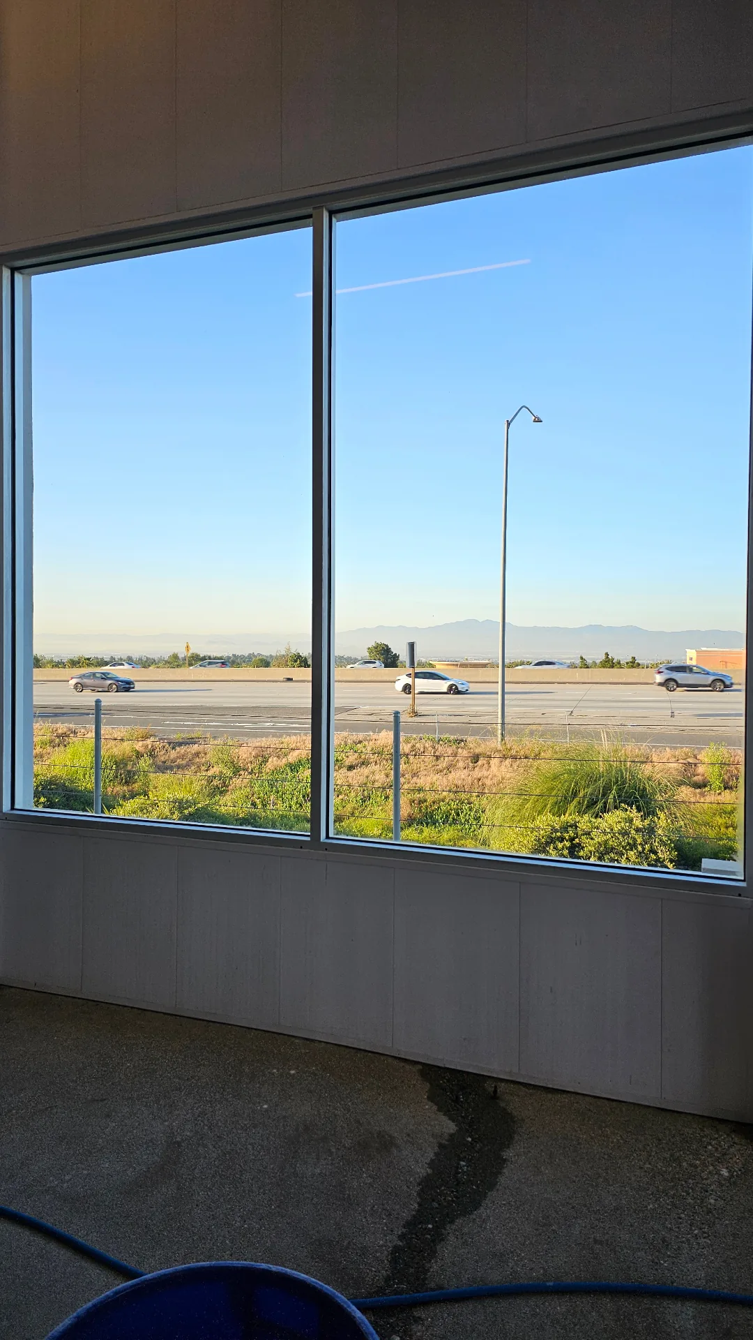 Crystal-clear commercial windows with a wide outdoor view after Transparent Solutions hard water removal
