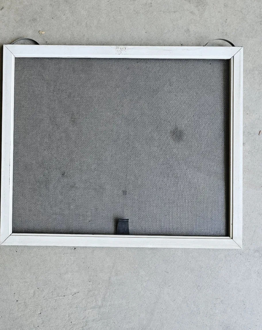 Same window screen rebuilt with fresh new mesh after Transparent Solutions screen replacement